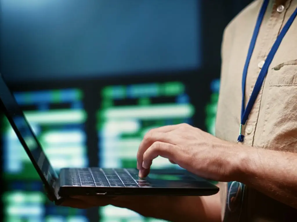 An IT with open laptop